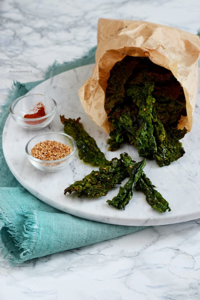 Kale chips made in oven served as appetizer in a paper bag