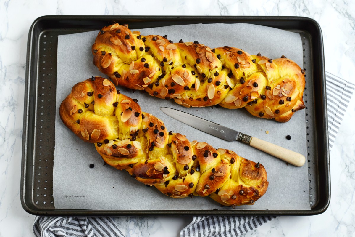 Tsoureki pane greco con cioccolato e mandorle, ricetta pasquale tipica greca nella foto prospettiva zenitale della teglia in cui sono adagiate due trecce di pane brioche cioccolato e mandorle